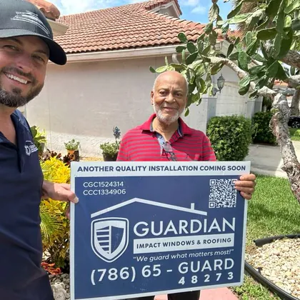 A Guardian team member with a family and a Guardian yard sign