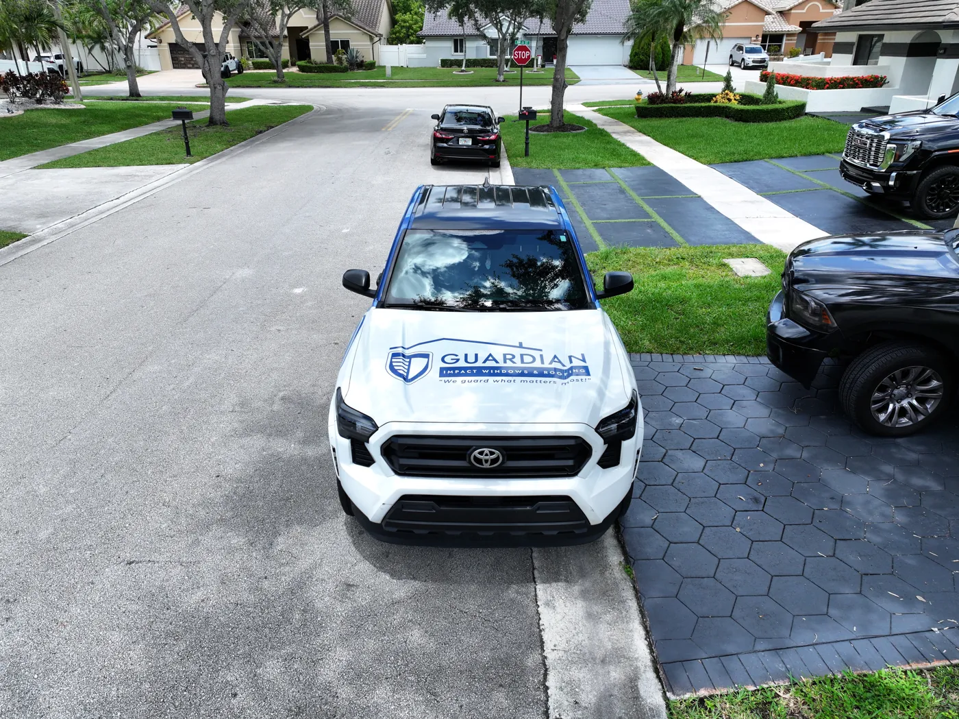 A Guardian service truck in a homeowner's driveway